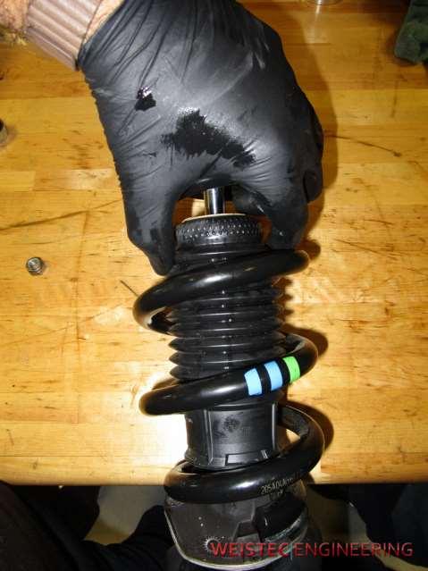 17. Remove the bump stop and dust boot by pulling it