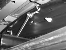 2. The driver-side emergency brake cable must be unbolted. Remove the nut and cable bracket, pull loose from the frame (Fig. 5). Retain the fasteners for re-attaching the cable bracket. fig.