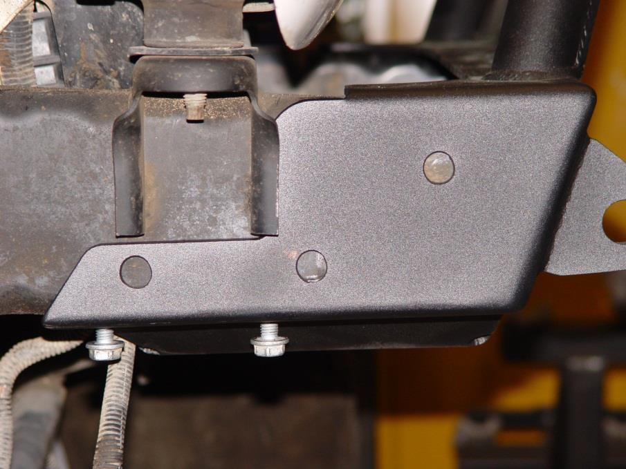 Slide the bumper all the way onto the frame rails and install the two swaybar bolts that are located on the bottom of each of frame rail and tighten.