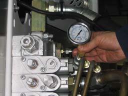 If gauge #1 indicates pressure, this may be caused by a faulty holding valve, faulty velocity fuse or hydraulic hoses not properly connected.