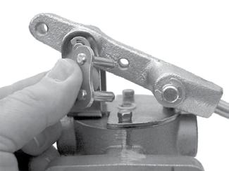 Place the valve on a flat surface with the valve piston facing down (Figure 17a). 4. Remove the retaining clip from the connection link.