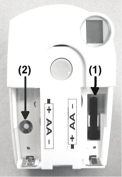 Remove both batteries from the valve operating mechanism. Remove the control pin by pressing on the position marked with a (1). Place the control pin onto the peg marked with a (2).