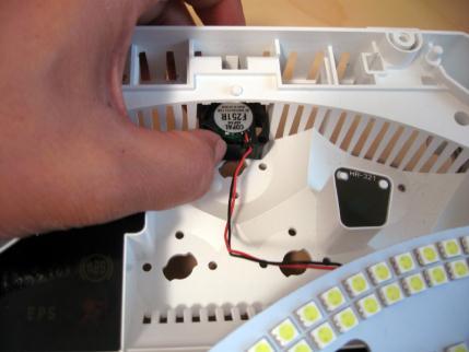 Insert the small fan from the LED board through the
