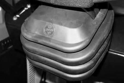 To tilt the steering wheel, pull the lever slightly downward and toward the operator seat. Position the steering wheel at the desired position, then release the lever.