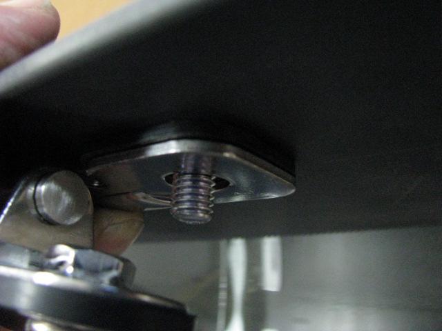 Place the washer and hinge pin retainer clip onto the studs followed by the flat washers, spring washers and nuts.