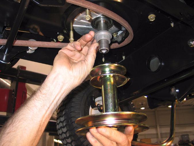 8. Carefully lower the pulley from the crankshaft and remove the belt from around the engine pulley. See Figure 34.