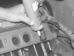 INSTALLATION PROCEDURE 1. With the intake gaskets in place, apply a small amount of RTV High Temp silicone sealer around the water passages on the intake manifold side (See Figure 4).