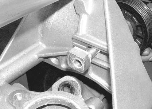 Install the Alternator Tensioning bracket under the passenger side bolt (See Figure 13). Align the tensioning bracket with the alternator and tighten the snout support/idler pulley bracket bolts.