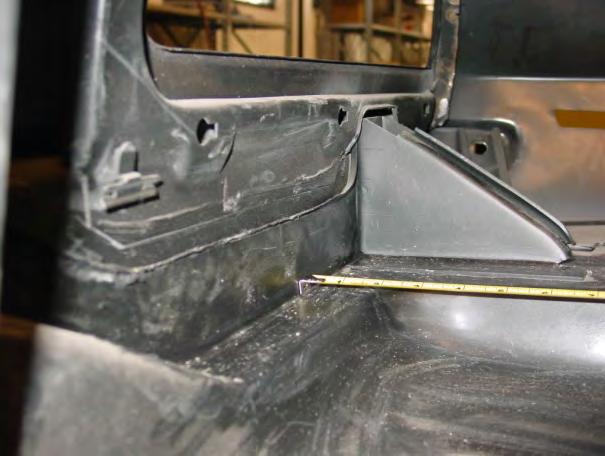 Fit the crossmember in the cut out area. Position it so the longer flange is toward the rear of the vehicle. It will sit on the trunk floor right above the rear frame rails.