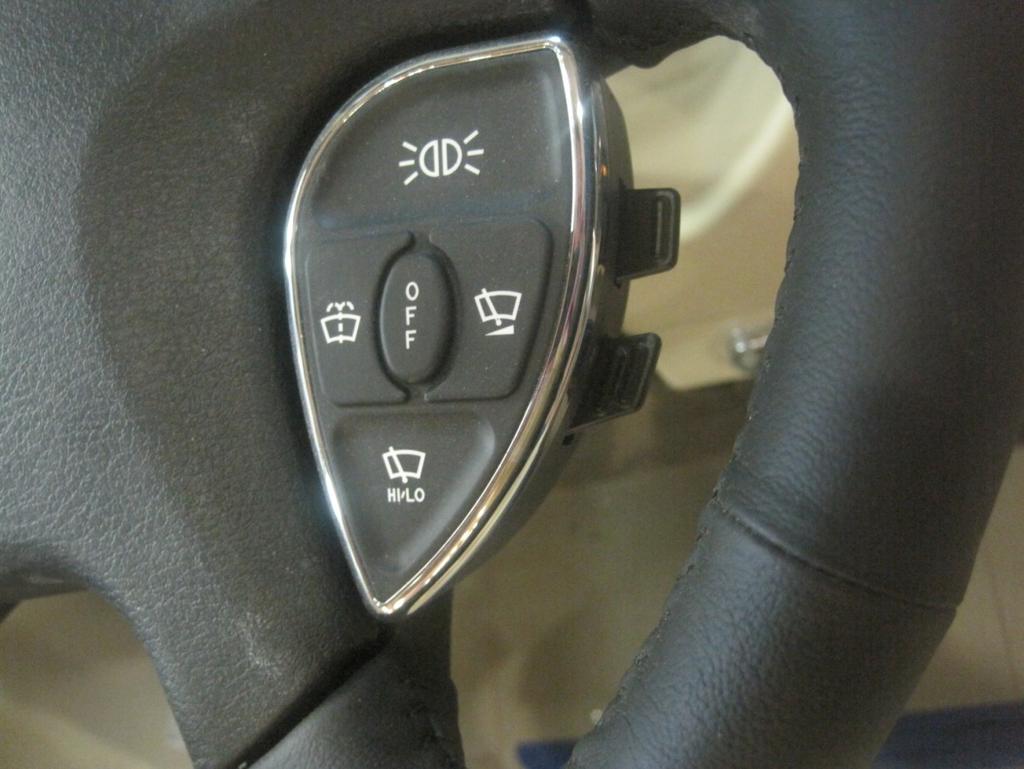 Included radio controls on steering wheel for easier access (Figure