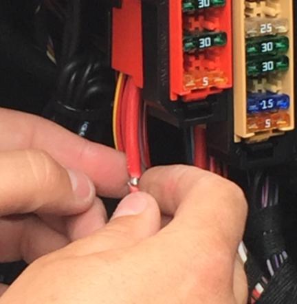 Locate a positive (permanent) 12v power source close to the Fusebox and, carefully expose the live cable, removing a small area of the surrounding plastic sheath, no more than 5mm in length.