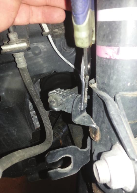 Remove brake hose retainer clip and separate