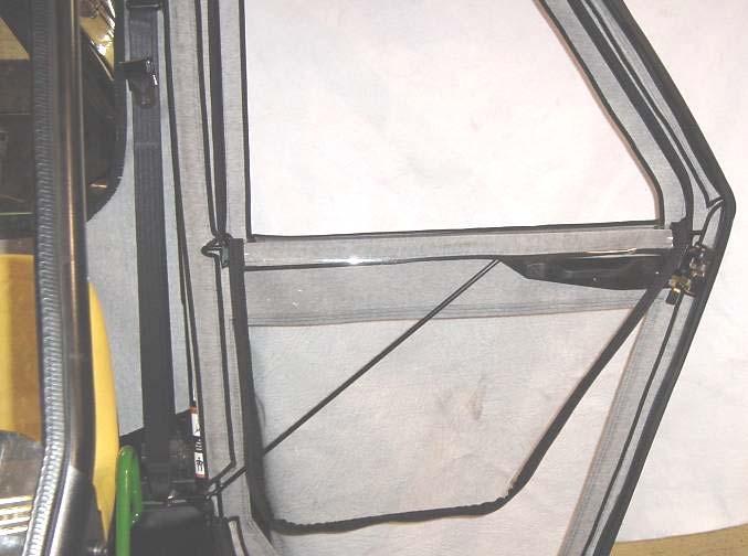 2 Per fig. 10.2, the zippered window in the rear curtain can be rolled up as shown using the three mated velcro straps shown.