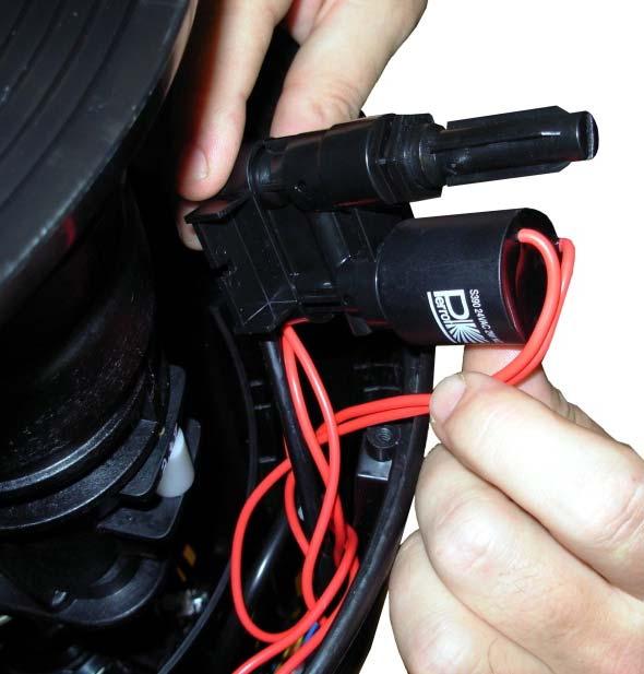 Twist out coil. When replacing the control unit, press back the mounting ring at the plug in connector and pull out the hose.