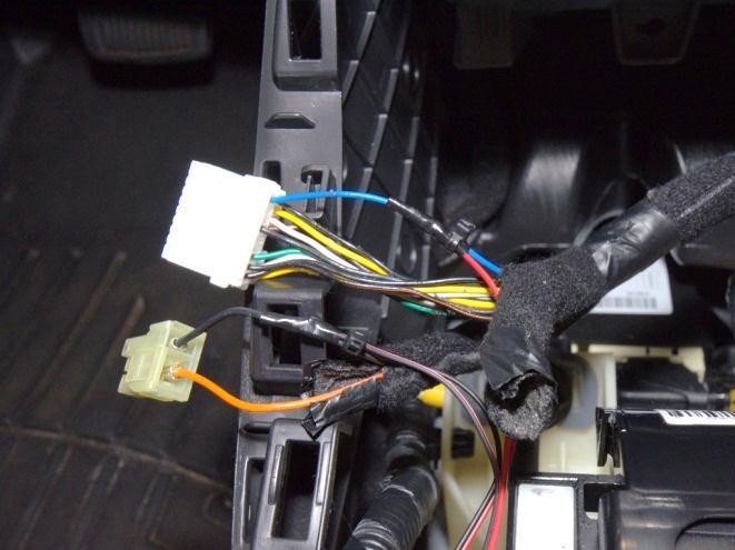 Take both black LED wires and twist them together and run them through the black car wire and wrap it around (V). Tape up the connection and zip tie to secure (W).