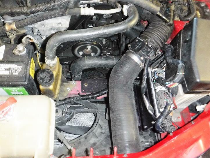 While holding the air deflector in position, tighten the tie-wrap as shown in Photo 2-23. Cut off the tiewrap end when complete. Reinstall your cold air intake setup.