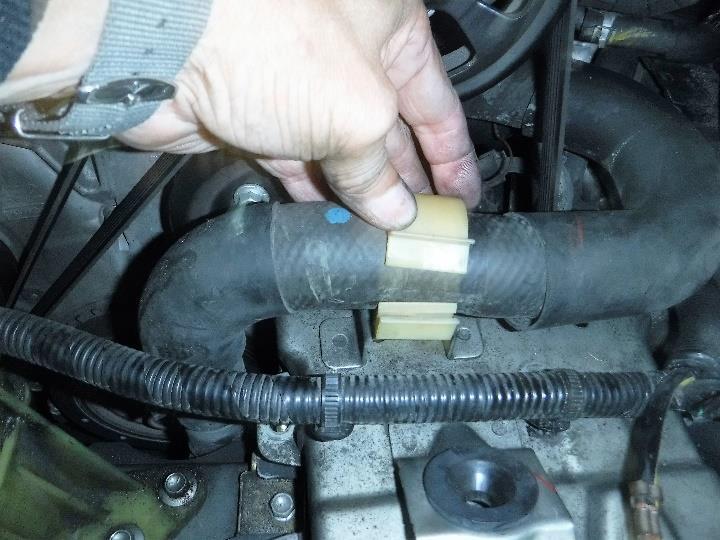 You can remove the hose clamp from the ECU top cover