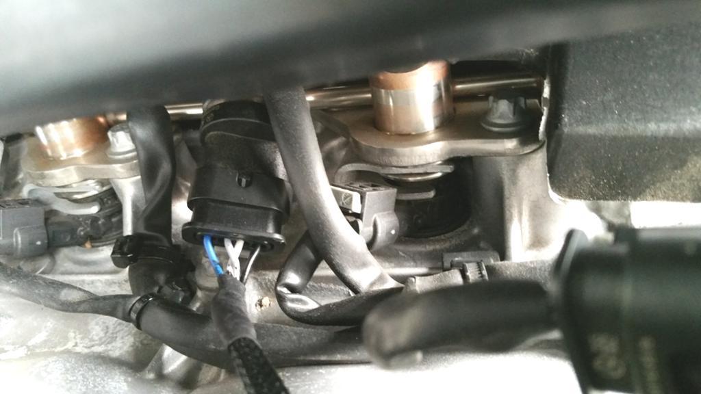 5. Locate the fuel rail sensor underneath the snorkel. It will have a connector that is identical to the 4-pin connector on the DINANTronics harness. Fuel Rail Sensor (lock is underneath) 6.