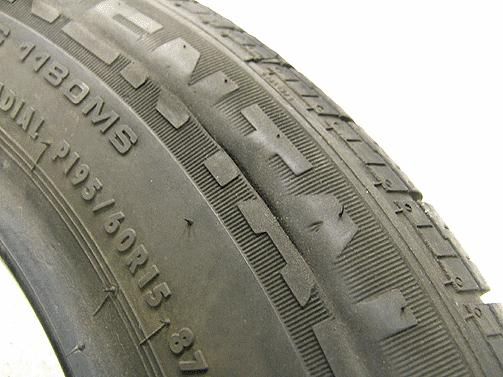 The next sample tire shows both sidewall wear, and cuts in a circum-radial line extending completely around the tire.