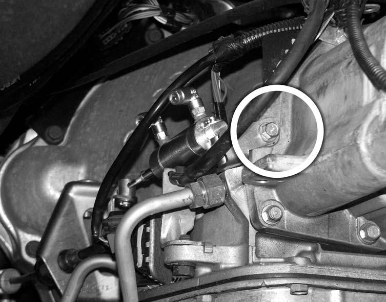 Loosen the lock bolt and remove the factory kick-down lever from the throttle valve shaft as shown in Figure 3. 7.