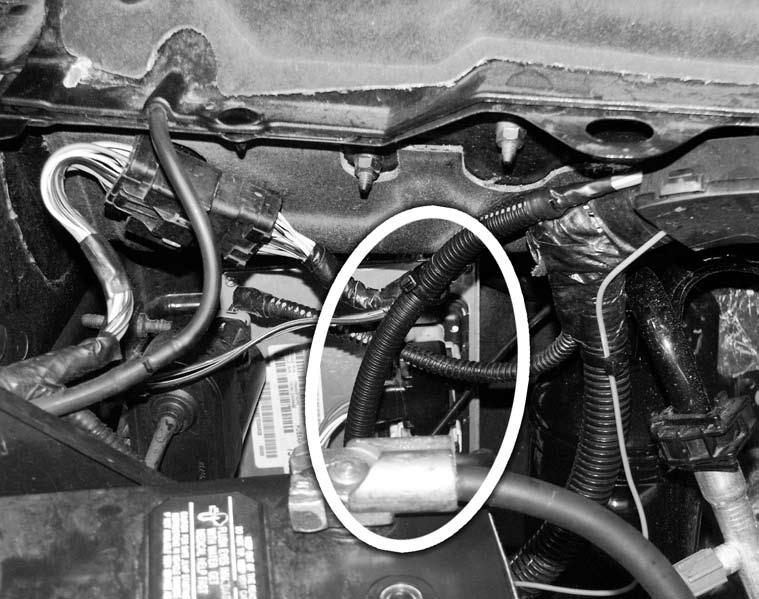 22. Locate the three (3) PCM connectors on the passenger side as shown in Figure 11. Find the orange wire with black stripe on the white PCM connector (the middle one). Cut the wire.