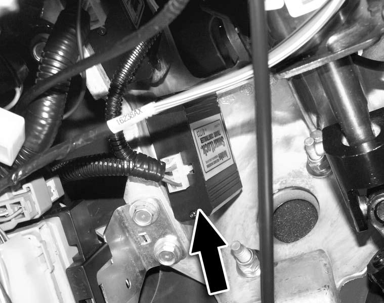 Figure 13 29. Locate a stud bolt on the left of the bottom of the steeling column and attach the black SmartLock wire with ring terminal to it.