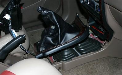 Tacoma: Shifter Removal: 4. You can now lift up on the front trim piece to disconnect the locking tabs and lift it over the shifters and out of the way. 1.
