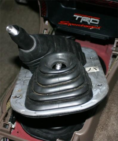 1. Remove the 4 screws that hold the shifter boot plate to the truck body and lift it over