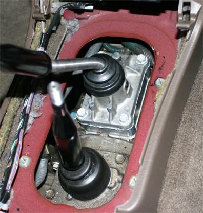 2. Using at 12mm socket, remove the 4 bolts (4-Wheel Drive) that hold the shifter base plate to the transmission.