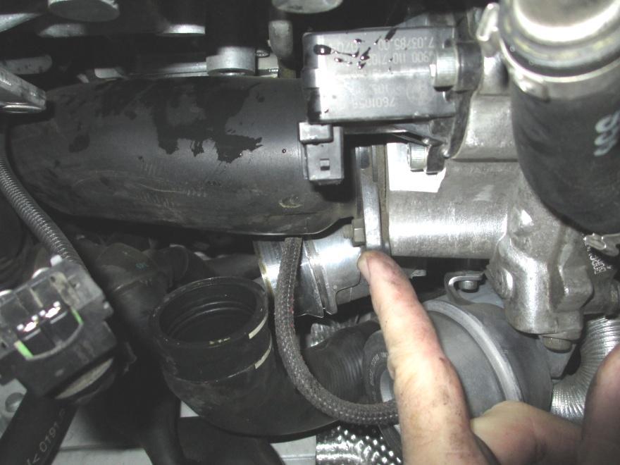 Remove the nut holding the plastic air intake tube to the turbocharger (do not lose the small steel