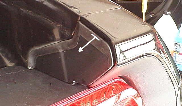 2) Remove one plastic wing nut that holds the trunk liner. Peel the liner back to expose the harness connector.