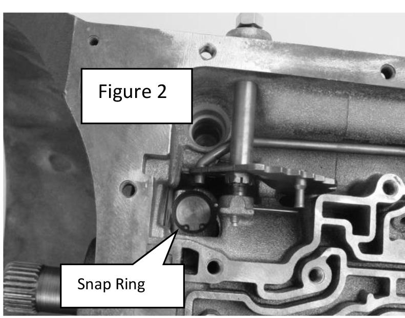4 STEP 5: Locate the pressure regulator snap ring in the transmission case near the selector lever linkage (See Figure 2). Push up on the aluminum sleeve and remove the snap ring.