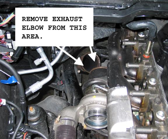 From underneath the vehicle, remove the down pipe-to-turbo elbow band clamp using a 10mm socket.