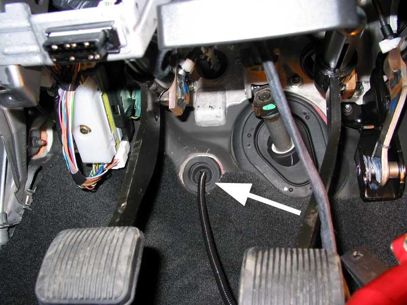 - 7 - Locate a grommet on the firewall and cut an opening in it to run the loom covered wiring through the firewall.