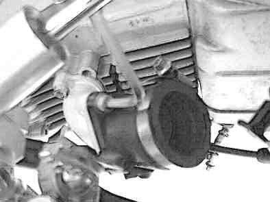 carburetor top cover and then through the spring. from upper level mark.