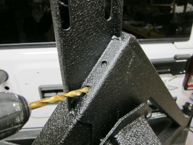 Then slide the 4 studs on the tire carrier bracket through the 3 rd brake light lower bracket and tire carrier