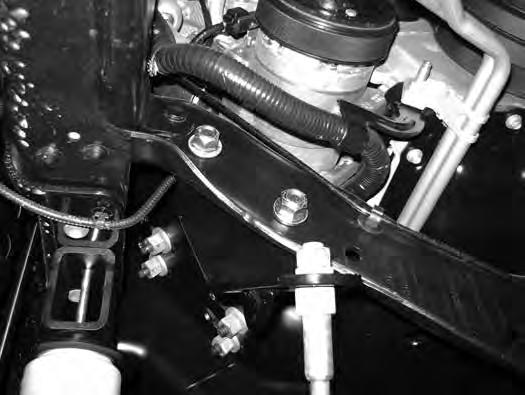 12. Install the new steering stabilizer bracket (01555) to the passenger s side of the engine crossmember using existing holes and new 1/2 x 1-1/4 bolts, nuts and washers (BP 657) (Fig 6).