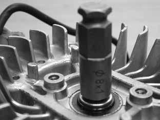 Removal of the starter and spark plug is requried. Refer to sections 6 and 8 if necessary. 16.
