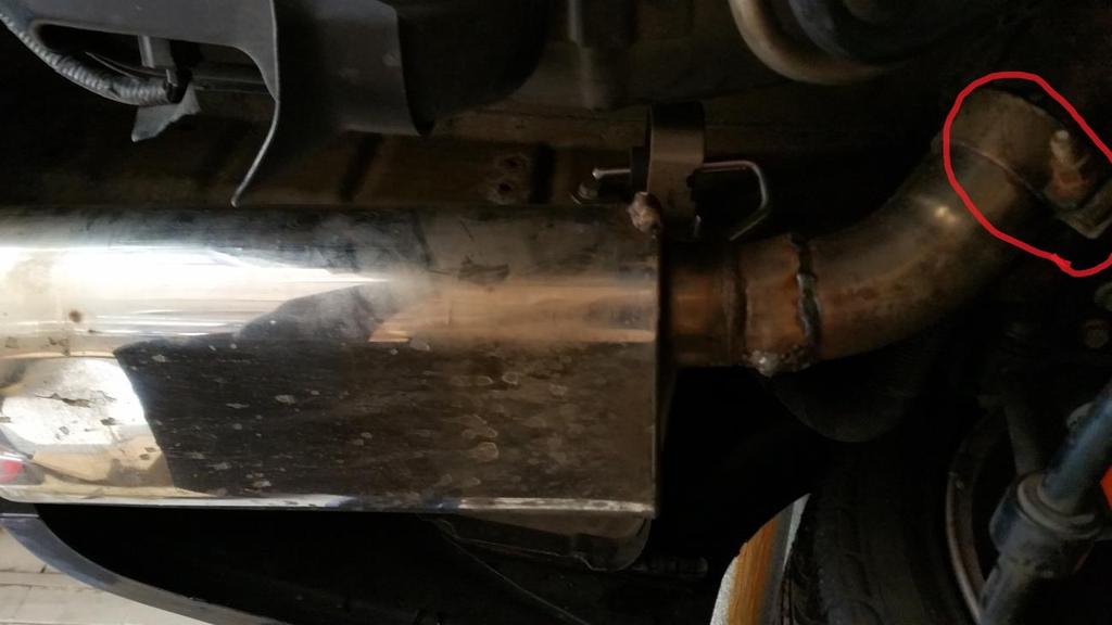 Left Muffler: 7. Once the muffler is loose, pull it out of the exhaust hangers and away from the vehicle.