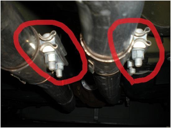 Using the ratchet, short extension and 15mm socket, loosen each of the two (2) bolts on one of the clamps