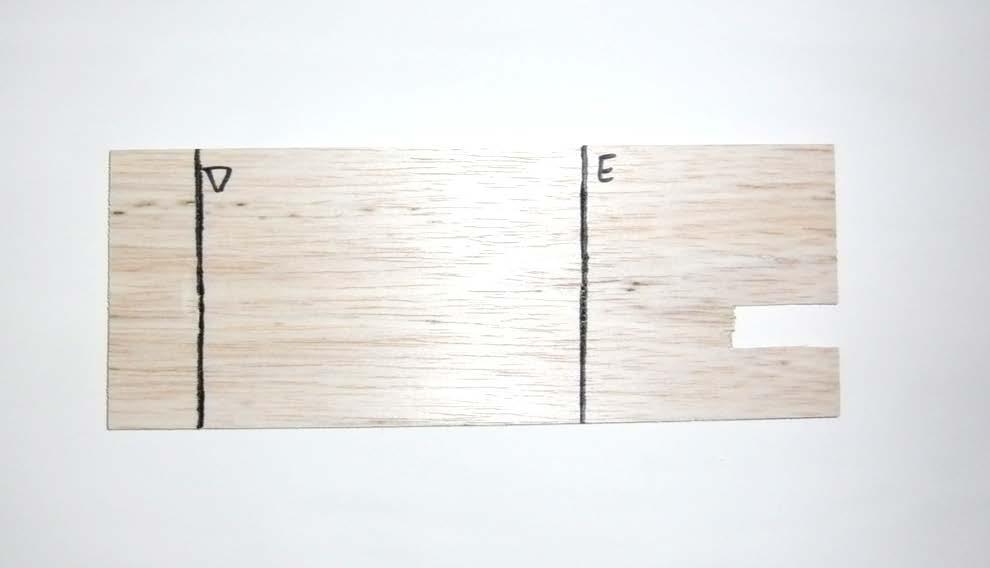 5. Turn over the balsa wood and draw a line one inch from the opposite side of the notch. Label this line D. 6.