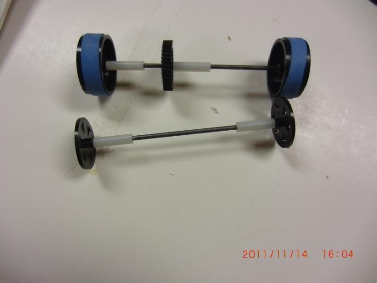 17 Front Axle Assembly 1. Place one of the two thin wheels flat on the table. 2.