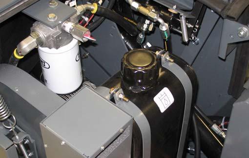 Machines (S/N 000000 005693) have a filler cap with a fluid level dipstick. The hydraulic fluid level should be between the full and add markings on the dipstick.