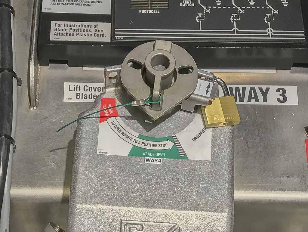 Locking Out Grounded Position To prevent operation of a motor operator into the Grounded position, insert a padlock through the operation selector and the