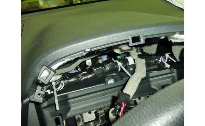 (l) Route the passenger side harness along the OE harness towards the radio opening.
