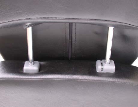 To lower headrest, push release tab towards the inside of the chair and lower the headrest to the seat(lower