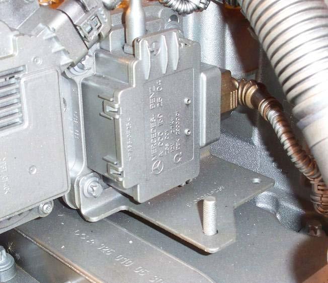 4. Remove mounting bolts securing the grid heater to the mixer housing. Remove and discard the attached relay ground bracket, if equipped. See Figure 1.