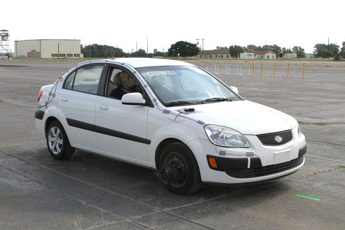 5.4 TEST DESCRIPTION Figure 5.2. Vehicle before Test No. 490025-4-1. The 2009 Kia Rio, traveling at a speed of 18.