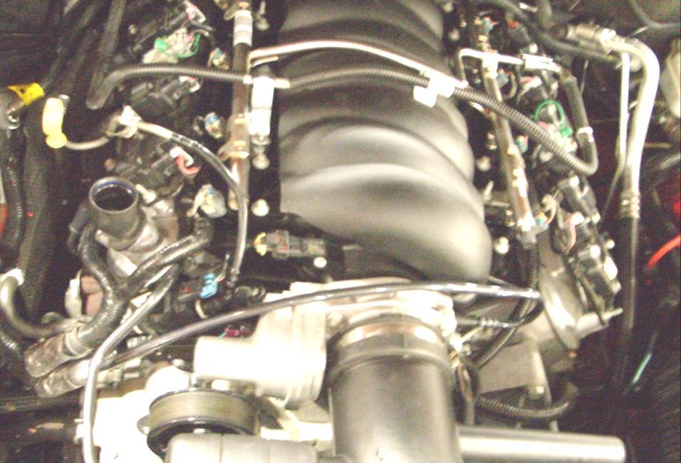 The VMV line will be routed underneath the coil cover. Note: Determine which coil pack your vehicle is equipped with from the image below.