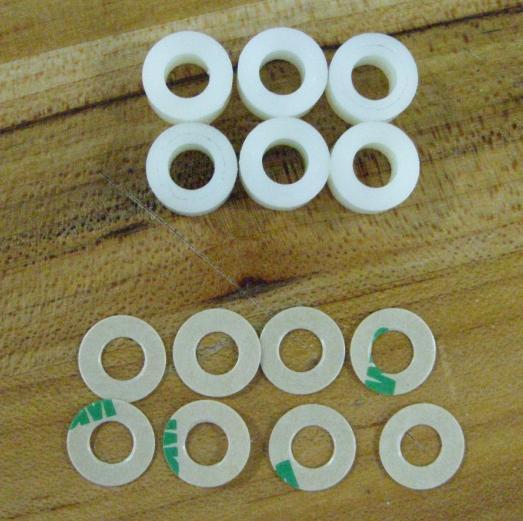 one (1) of the supplied spacers. An additional two (2) spare adhesive discs are included. 22.